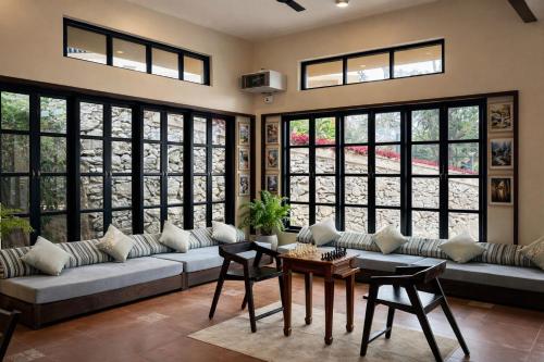 a living room with a couch and a table at Nirjhara Coorg in Somvārpet