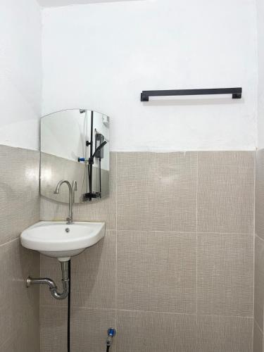 a bathroom with a sink and a mirror at GetAway Apartment in El Nido