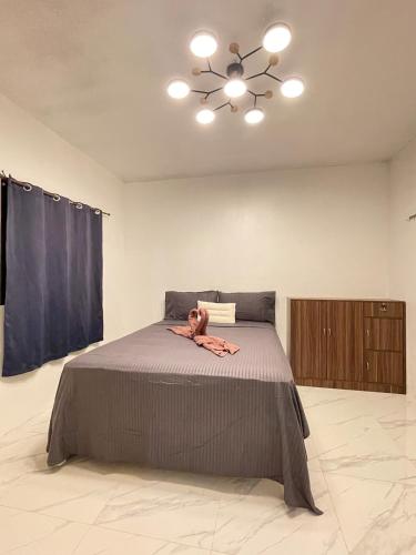 a woman laying on a bed in a bedroom at GetAway Apartment in El Nido