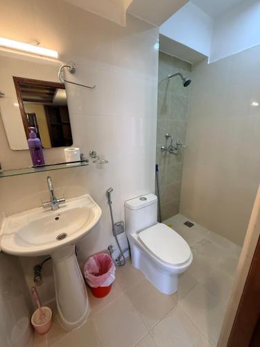 a bathroom with a toilet and a sink and a shower at Sacred Trails Kathmandu Accommodation in Kathmandu