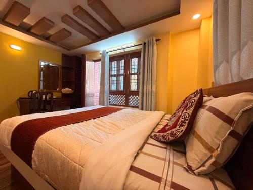 a bedroom with a bed with two pillows on it at Sacred Trails Kathmandu Accommodation in Kathmandu