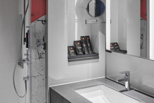 a bathroom with a sink and a mirror at Radisson RED Cebu Mandaue in Cebu City