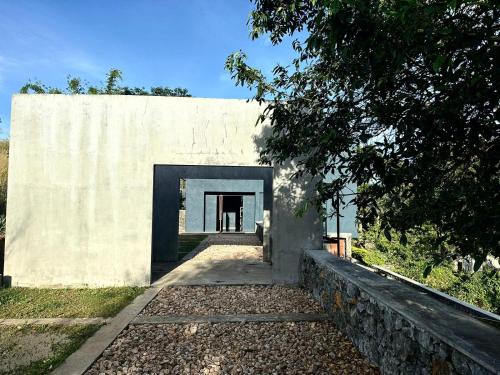 a building with a doorway in the side of it at Romance Valley Haputale in Haputale