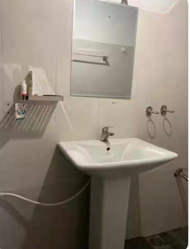a bathroom with a white sink and a mirror at Dragon beach in Dondra West