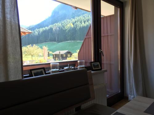 a room with a window with a view of a mountain at Ferienwohnung Kogelblick Gosau in Gosau