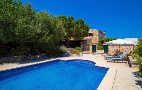 a swimming pool in a yard next to a house at Sos Monjos in Artá