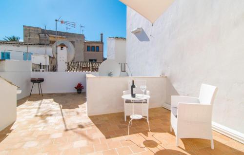 a patio with a table and chairs on a building at Convent in Alcudia