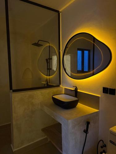 a bathroom with a sink and a mirror at Villa Moja in Nungwi
