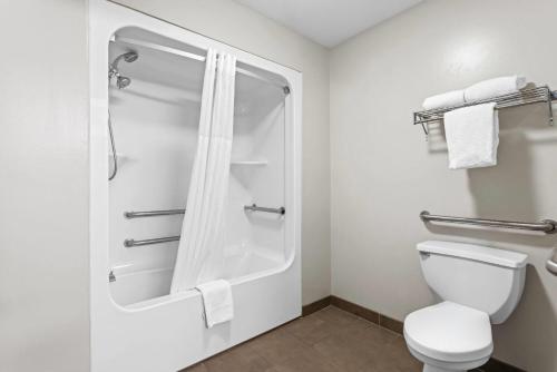 a bathroom with a shower and a toilet at Super 8 by Wyndham Valdosta GA I-75 in Valdosta