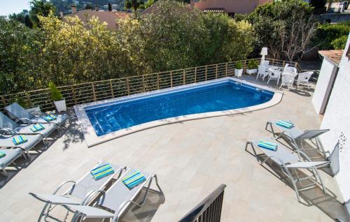 a swimming pool with lounge chairs and a swimming pool at Corazon in Canyamel