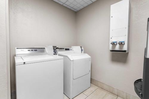 a white washer and dryer in a room at Days Inn & Suites by Wyndham Ridgeland in Ridgeland