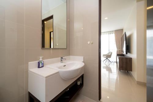a white bathroom with a sink and a mirror at Luxury 5 bed Laguna Park no Pool in Bang Tao Beach