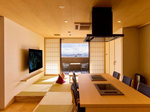 a dining room with a table and chairs and a living room at Rakuten STAY Awara Onsen in Awara