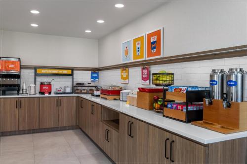 a large kitchen with wooden cabinets in a store at Hampton Inn Owensboro in Owensboro