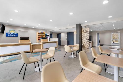 a waiting room at adqinn dental clinic with tables and chairs at Days Inn & Suites by Wyndham Brandon Amphitheater in Brandon