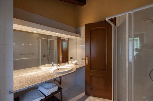 a bathroom with two sinks and a shower at Alle Robinie in Pradamano