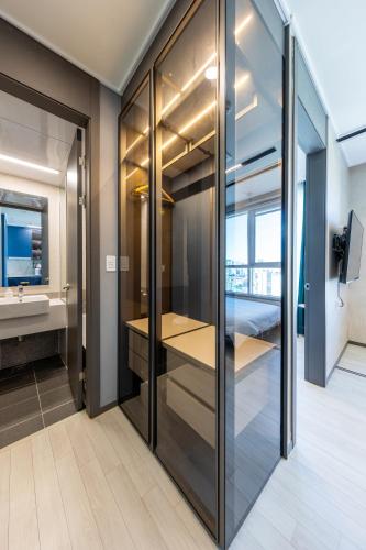 a bathroom with glass doors and a sink at Nampo Stay 99 in Busan