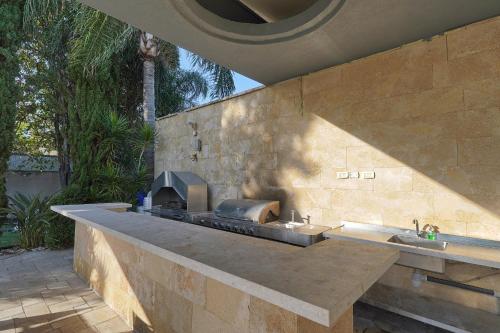 a kitchen with a stone wall with a stove at S Villa Place נהריה in Nahariyya