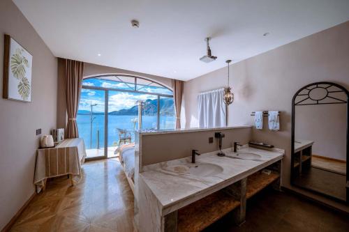 a bathroom with two sinks and a large window at Jade moon in Dali