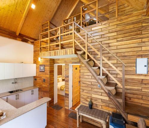 a spiral staircase in a wooden wall in a kitchen at Megha Resort & Villas, Dehradun-Where Nature Pampers You in Dehradun