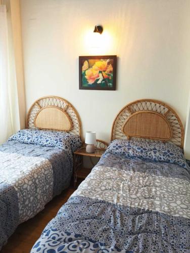 a room with two beds and a table at El Rinconcito in El Ronquillo