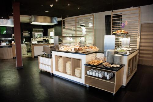 a kitchen with a counter with food on it at TUI BLUE Schladming in Schladming