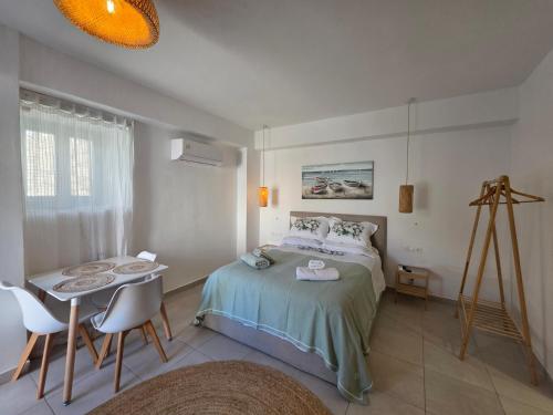 a bedroom with a bed and a table and chairs at Akti luxury aparts in Frý