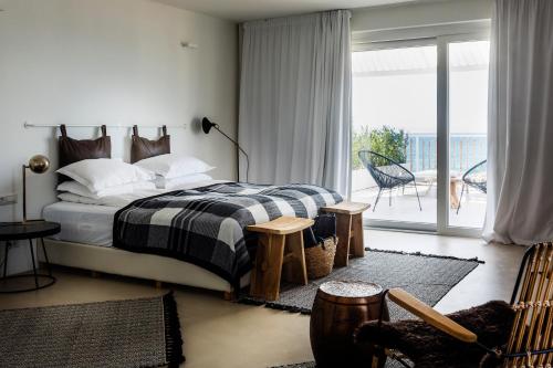 a bedroom with a bed and a balcony at Sea Sense Boutique Villa & Relax Zone in Sozopol