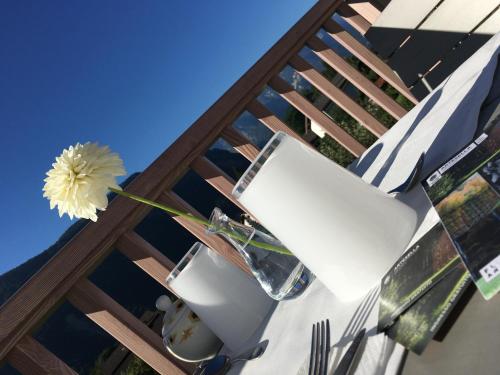 a flower in a vase on a table with a toilet at B&B Il Piccolo Principe room and breakfast in Bieno