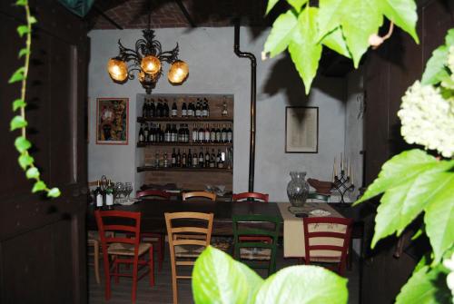 a dining room with a table and red chairs at Apartments Casa nel Verde in Rocchetta Tanaro