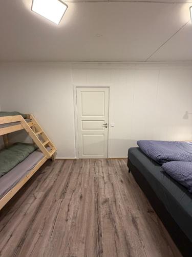 a bedroom with two bunk beds and a door at Kirkenes down town apartments in Kirkenes