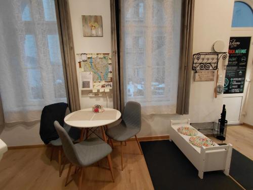 a room with a table and chairs and a crib at Bárka Home in downtown Buda in Budapest
