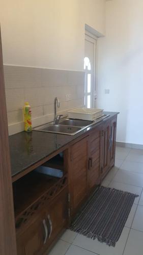 a kitchen with a sink and a counter top at Nashu Three bedroom Townhouse in Dambani