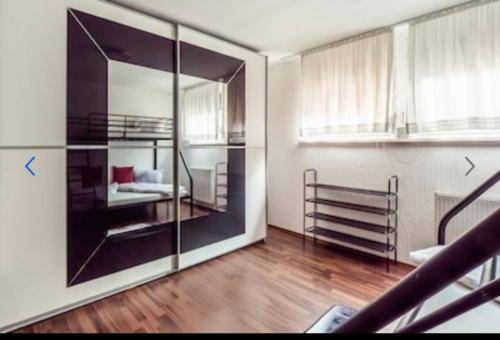 a room with a bedroom with a bed and a mirror at Haus Schwarzwald Marie in Mahlberg