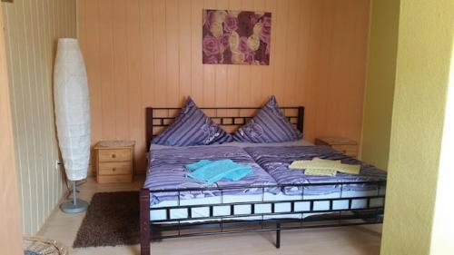 a bedroom with a bed with purple pillows at Zimmervermietung M&R Bertuch in Jüterbog