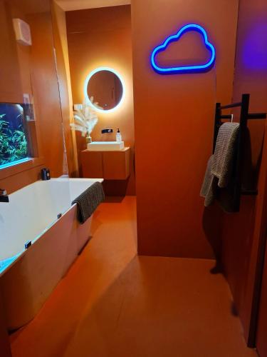 a bathroom with a heart sign on the wall at Nordic Noir Cabin in Queenstown