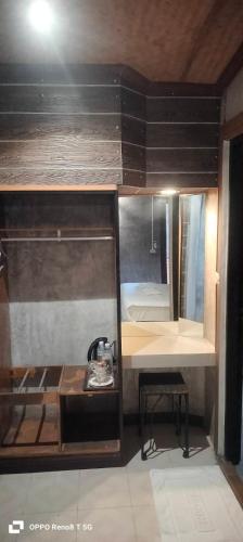 a small room with a bunk bed and a desk at เวียงล้านนา รีสอร์ท in Ban Muang Pha