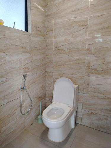 a bathroom with a toilet and a shower at Sanyan Retreat in Jeram