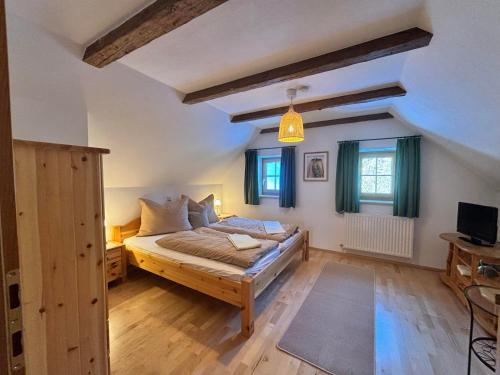 a bedroom with a bed and two windows at Huber's Ferienhaus 28 in Leutschach
