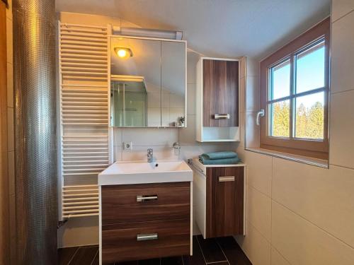 a bathroom with a sink and a window at Huber's Ferienhaus 28 in Leutschach