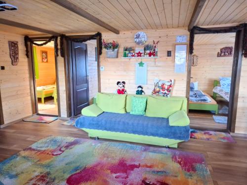 a living room with a couch in a room at Mounty vendégház in Borzont