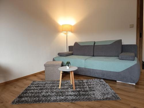 a living room with a couch and a table at Apartmán U nás in Malá Morávka