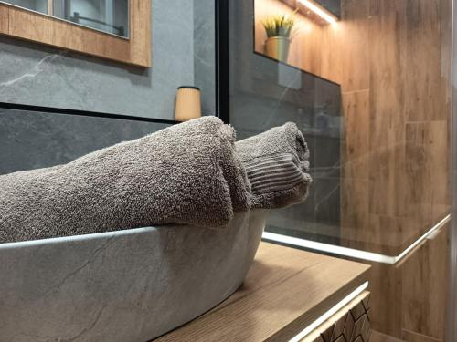 a bathroom with a stone bath tub with a window at Apartmán U nás in Malá Morávka