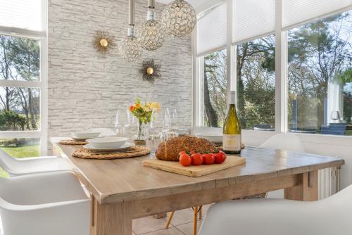 a dining room with a table with a basket of tomatoes at Villa Beach & Golf in Julianadorp