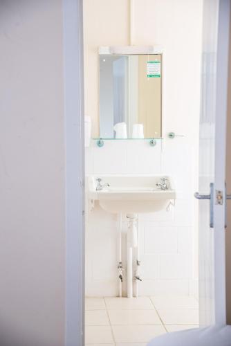 a bathroom with a sink and a mirror at The Dolphin Hotel in Wincanton