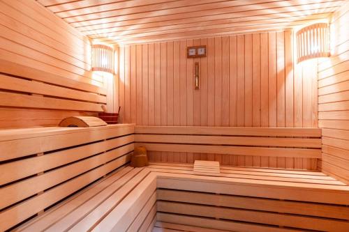 a sauna with wooden paneled walls and wooden floors at Apartment Pržno See View in Pržno