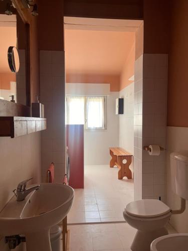 a bathroom with a sink and a toilet at Urban Po Mansarda in Santa Maria Maddalena