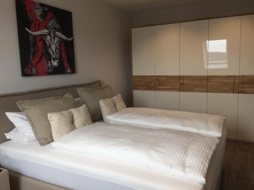 a bedroom with two beds and a painting on the wall at Boardinghaus Götterhimmel in Obernburg am Main