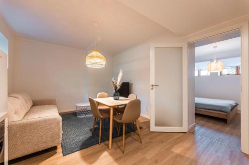 a living room with a table and a couch at Komandandi Smart Stay City Center Apartments in Kuressaare