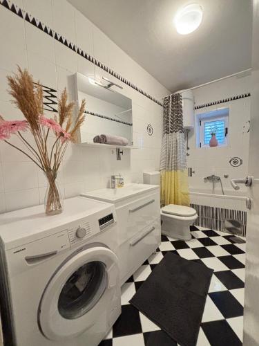 a bathroom with a washing machine and a sink at LEGRAND Town Center in Makarska